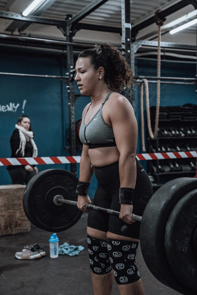 Woman doing deadlifts with a barbell