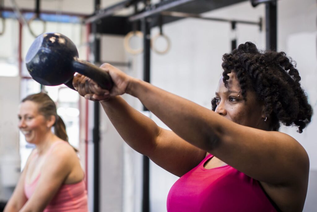 A group of women getting stronger doing kettlebell swings